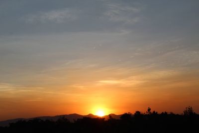 Scenic view of silhouette mountains against sky during sunset