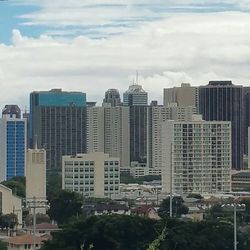 Cityscape against cloudy sky