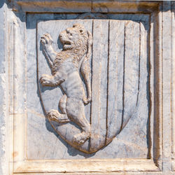 Detail of coats of arms in stone on the facade of a florentine medieval church