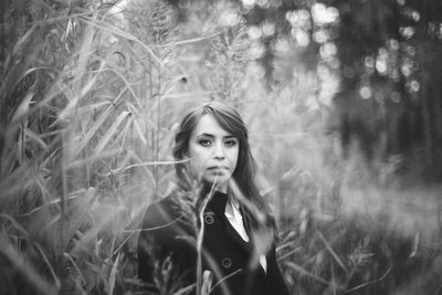 Portrait of beautiful young woman on field