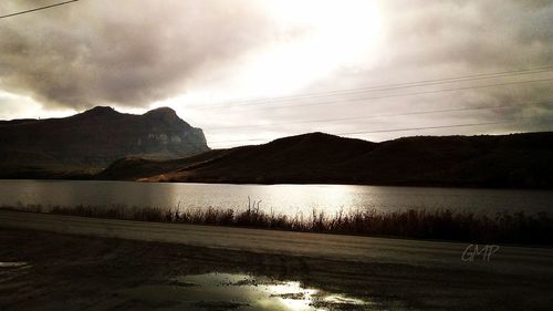 Scenic view of lake against dramatic sky