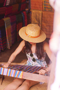  woman wearing hat wile working on floor