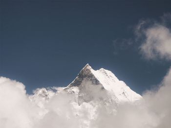 Low angle view of snowcapped mountain against sky