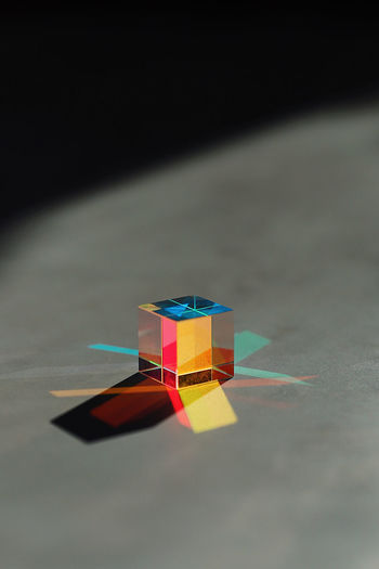 Cube shape on multi colored diagram on table