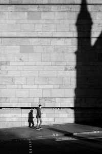 Shadow of people walking on road