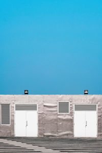 Low angle view of building against clear blue sky