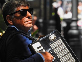 Portrait of man holding sunglasses