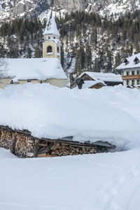 Snow covered buildings against clear sky