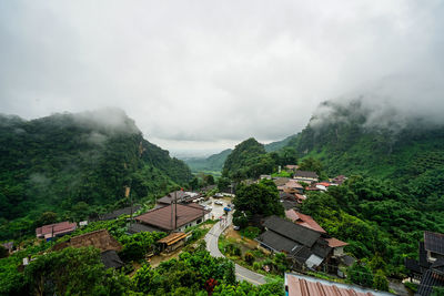 High angle view of trees and buildings against sky