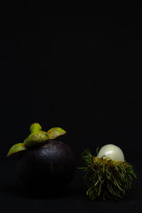 Close-up of fruits against black background