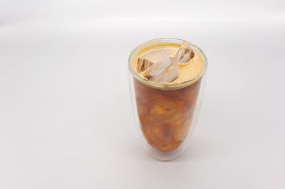 High angle view of ice tea against white background