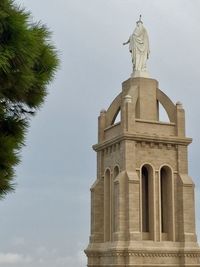 Low angle view of statue against building