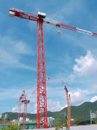 Low angle view of crane against sky