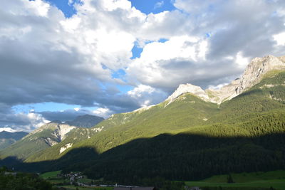 Scenic view of mountains against cloudy sky