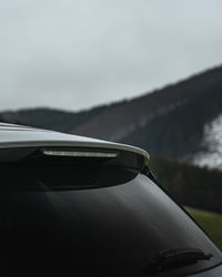 Close-up of car on road against sky