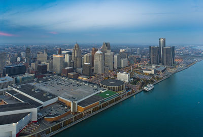 High angle view of cityscape by sea against sky