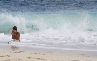 Shirtless boy at beach