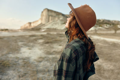 Rear view of woman standing against sky