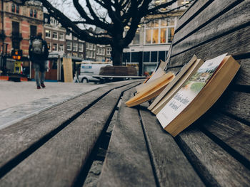 Man reading book on table in city