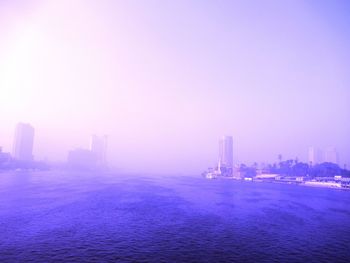 Scenic view of sea and buildings against sky