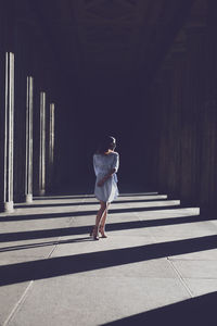 Woman standing at colonnade