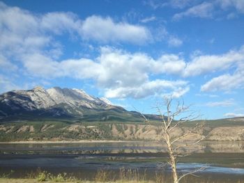 Scenic view of mountains against cloudy sky