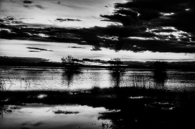 Scenic view of lake against sky at dusk