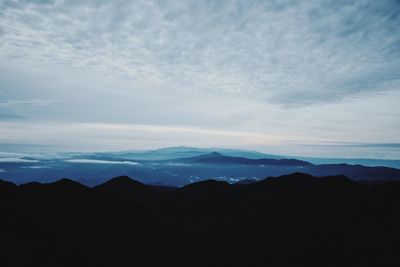 Scenic view of silhouette mountains against sky