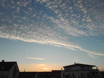 Low angle view of buildings against sky during sunset