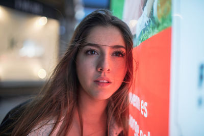 Close-up of beautiful young woman looking away