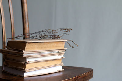 Stack of books on table against wall