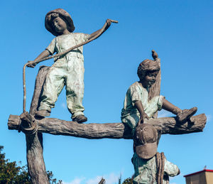 Low angle view of statue against clear blue sky