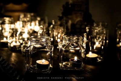 Close-up of lit tea light candles in temple