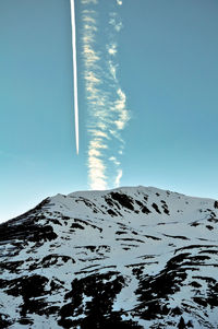 Scenic view of snowcapped mountain against blue sky