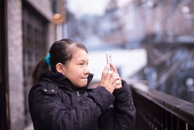 Close-up of man smoking cigarette in city