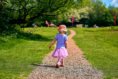 Full length portrait of girl standing on field