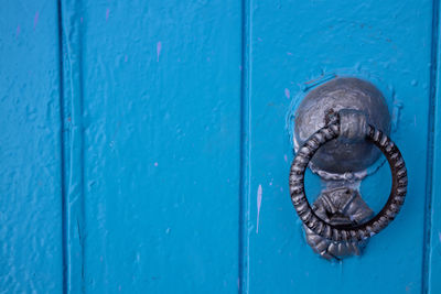 Close-up of blue door knocker