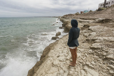 Side view of woman standing on beach