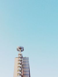 Low angle view of modern building against clear sky on sunny day