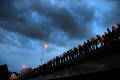 Low angle view of illuminated lights against sky at dusk