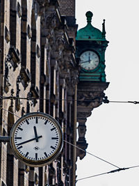 Low angle view of clock tower against cloudy sky