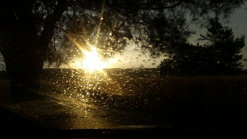 Sun seen through wet glass window during rainy season