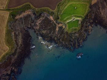 Aerial view of sea by cliffs