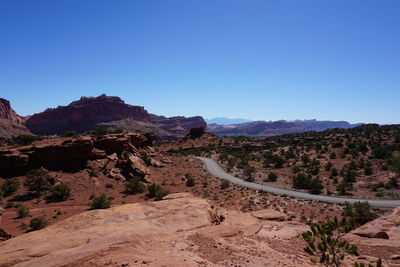 Scenic view of mountains against clear blue sky