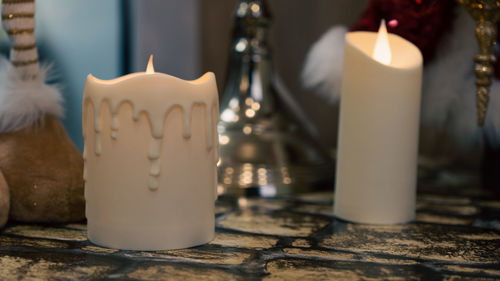 Close-up of lit candles on table in temple