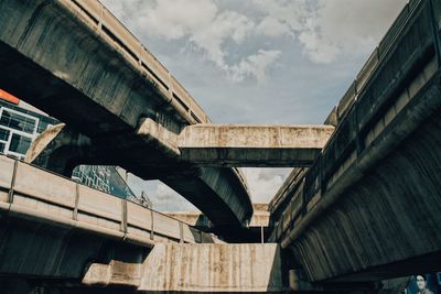 Low angle view of bridge against sky in city