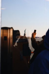 Statue in city against clear sky