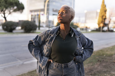 Woman standing with hands on hips at roadside