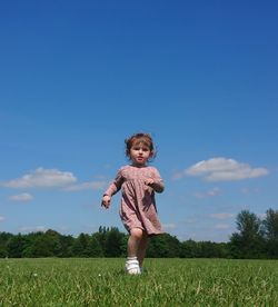 Full length of cute baby girl on field