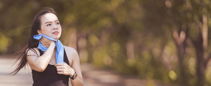 Portrait of young woman looking away outdoors